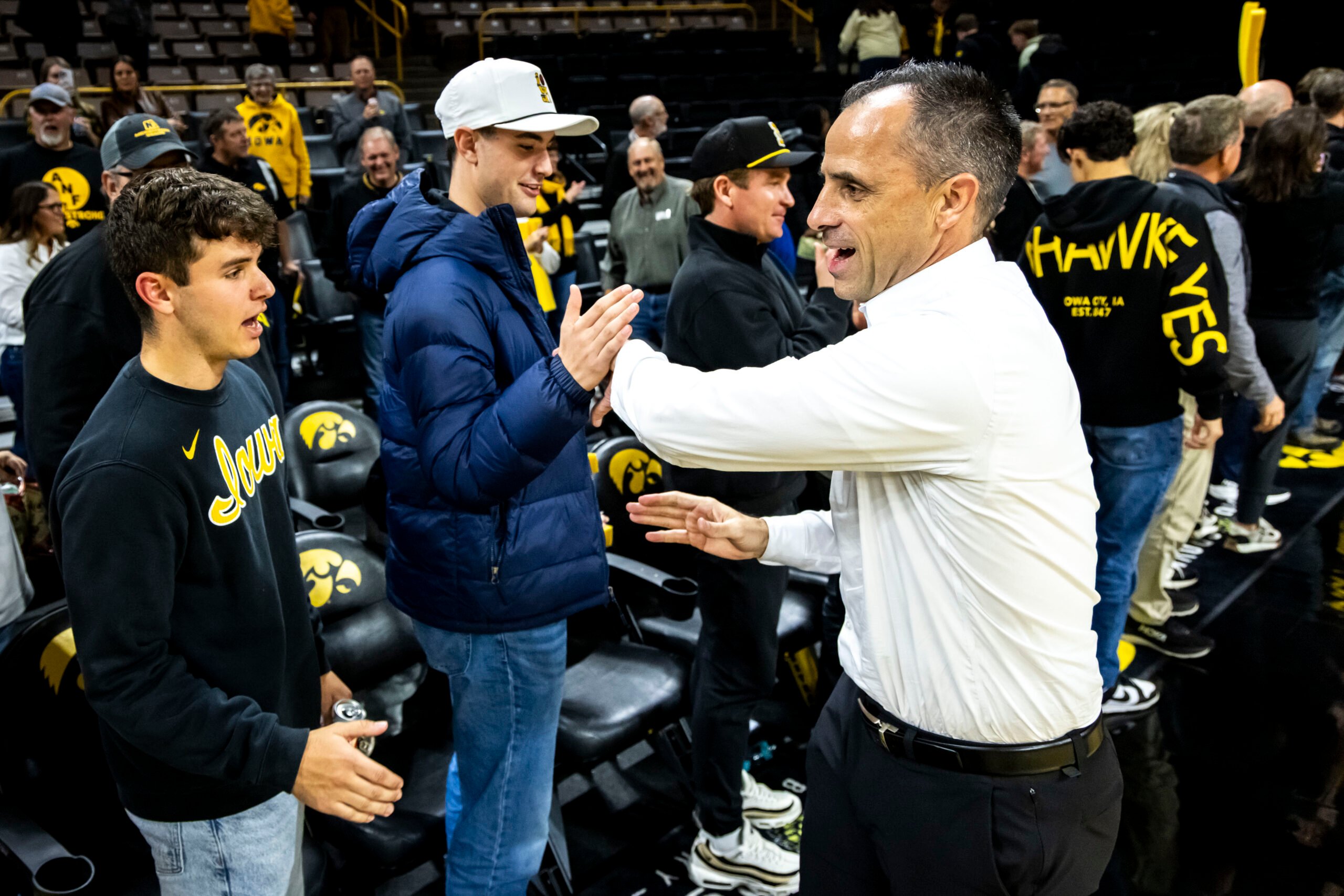 Iowa head coach Ben McCollum high-fives fans after a NCAA men's basketball game against Southeast Missouri State, Tuesday, Nov. 18, 2025, at Carver-Hawkeye Arena in Iowa City, Iowa. MANDATORY CREDIT: Joseph Cress/Think Iowa City