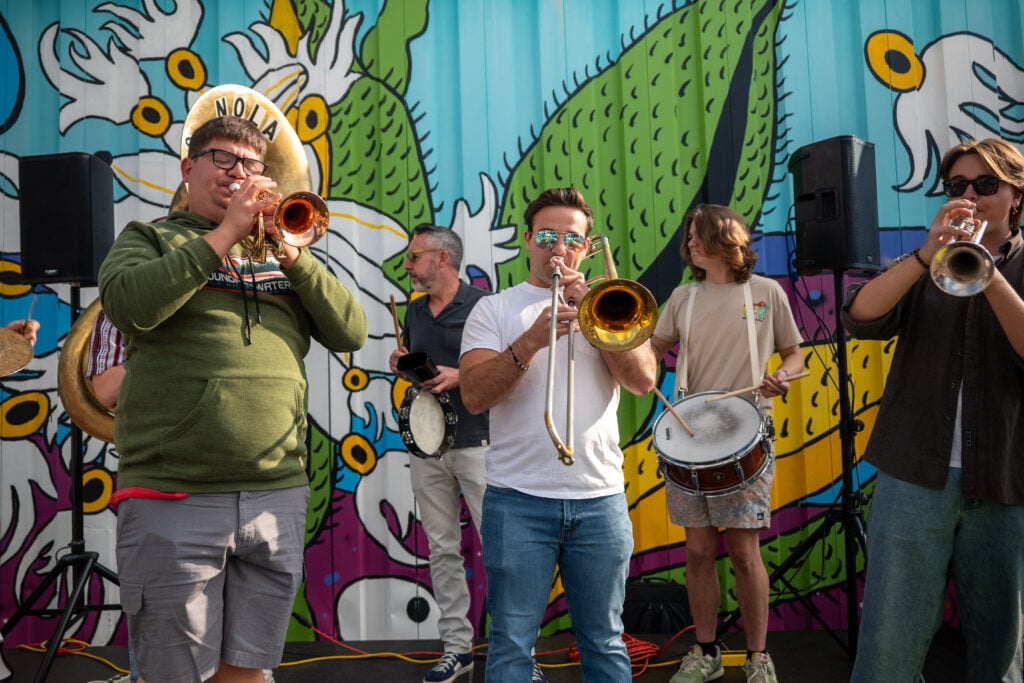 People participating in a ribbon‑cutting ceremony at the Bike Library’s new facility in Iowa City, IA